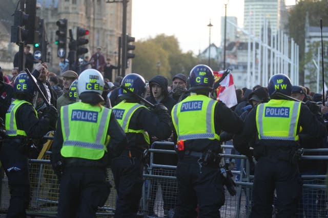Counter-protesters and police in Parliament Square in central London (PA)