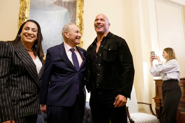 <p>Senate Majority Leader Chuck Schumer (D-NY) poses for photos with actor Dwayne Johnson (R) and XFL Co-Owner and CEO Dany Garcia (L) in his office at the U.S. Capitol Building on 15 November 2023 in Washington DC.</p>
