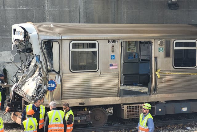 <p>This handout photo provided by the Chicago Fire Department on November 16, 2023, shows workers examining the damage to a CTA train in Chicago, Illinois</p>