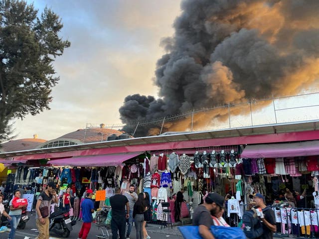 <p>Smoke from a fire rises out of a shoe warehouse near the zocalo in Mexico City on 16 November</p>