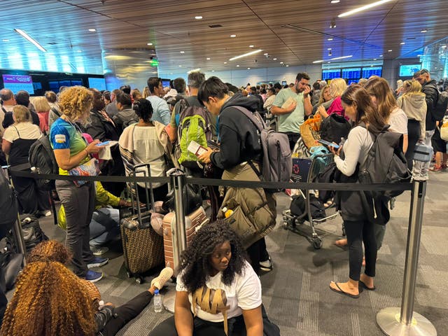 <p>Storm damage: Passengers waiting at Doha airport waiting to be rebooked</p>