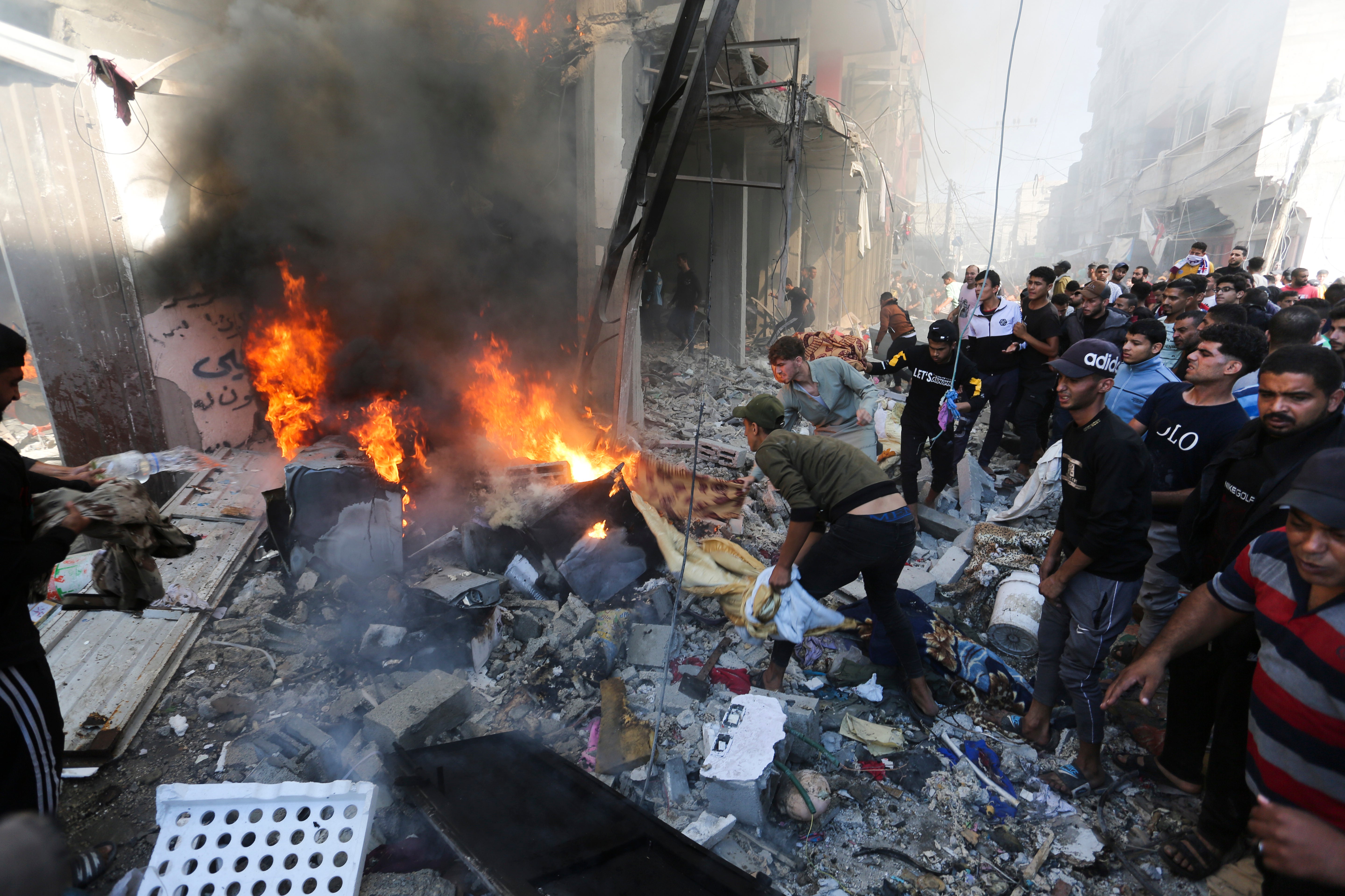 Palestinians look for survivors after an Israeli strike on Rafah, in the Gaza Strip, on Friday