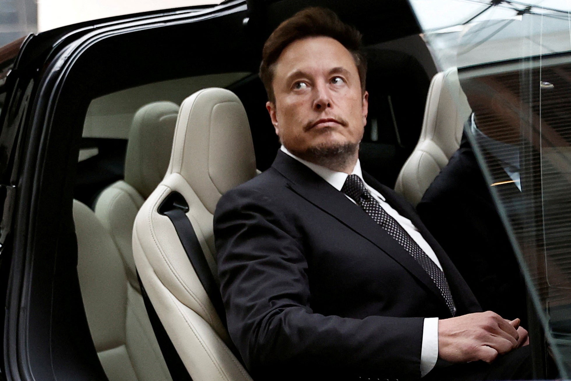 Tesla Chief Executive Officer Elon Musk gets in a Tesla car as he leaves a hotel in Beijing, China 31 May 2023