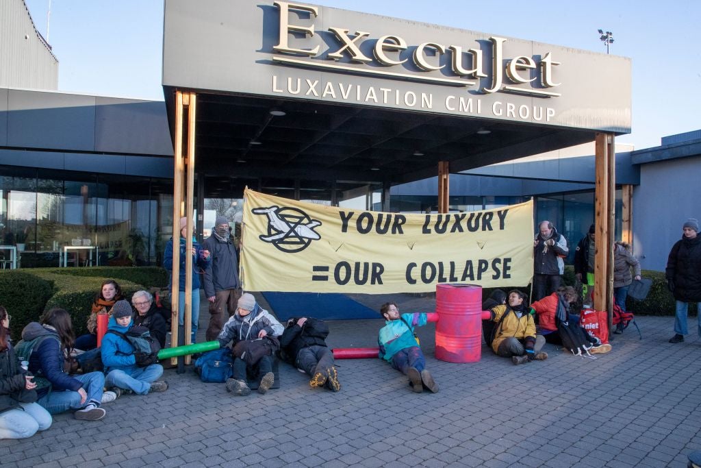 Climate activists of Extinction Rebellion hold a protest action against private jets at the ExecuJet Aviation Group in Zaventem, near Brussels Airport, Monday 13 February 2023