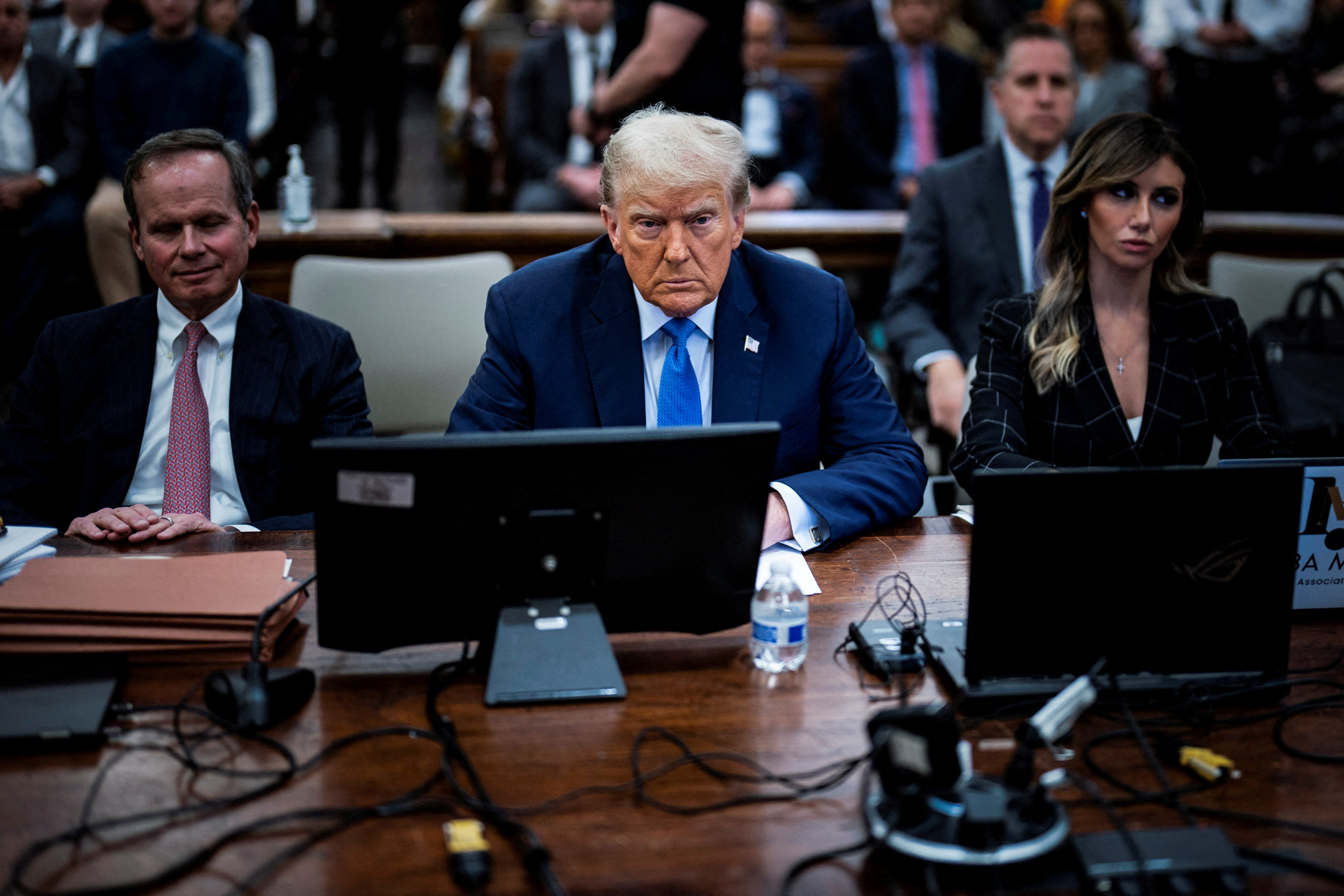 Donald Trump sits with his attorneys Christoper Kise, left, and Alina Habba, right, during his civil fraud trial in New York City.