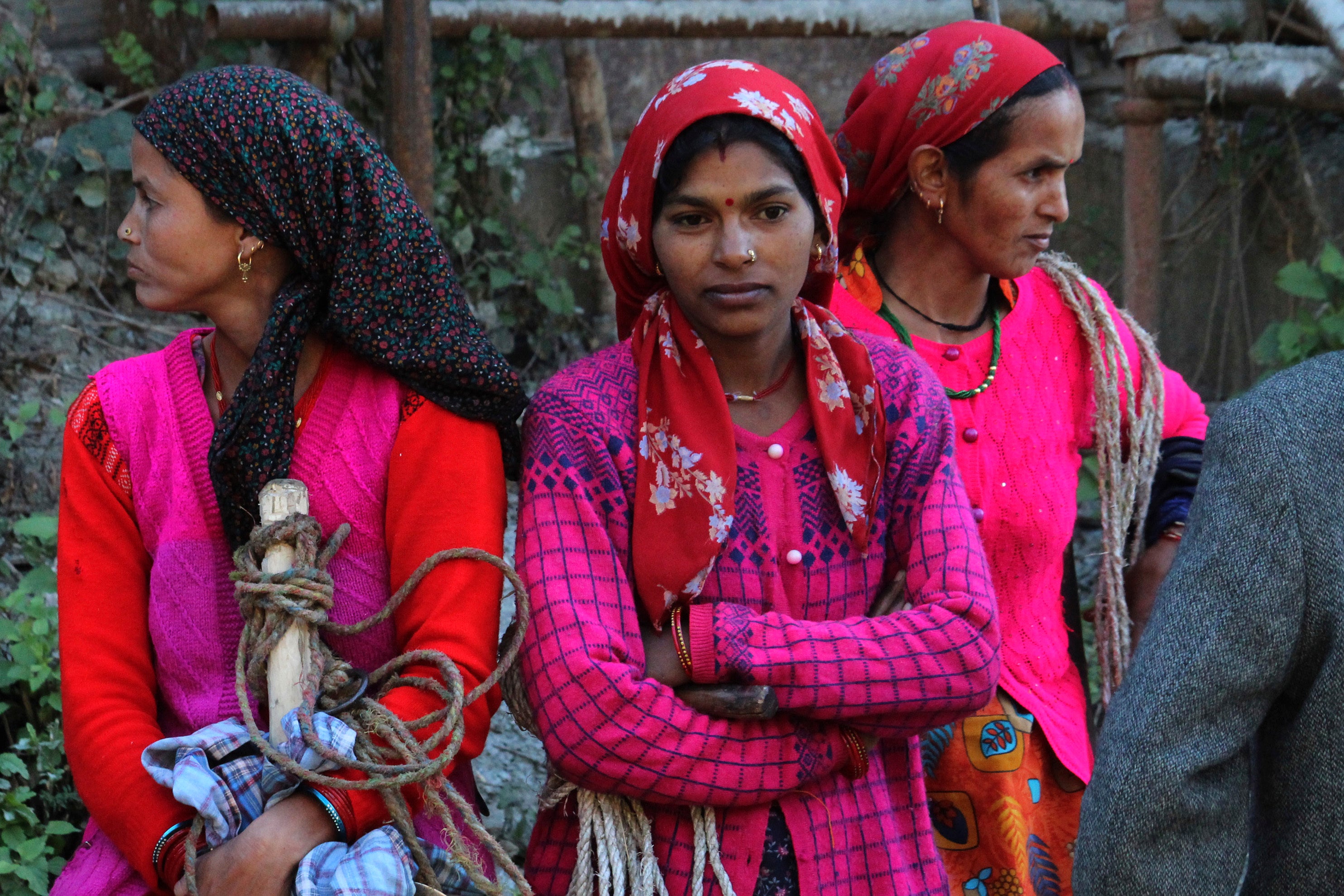 Locals watch rescue work in progress at the site of an under-construction road tunnel that collapsed in mountainous Uttarakhand state