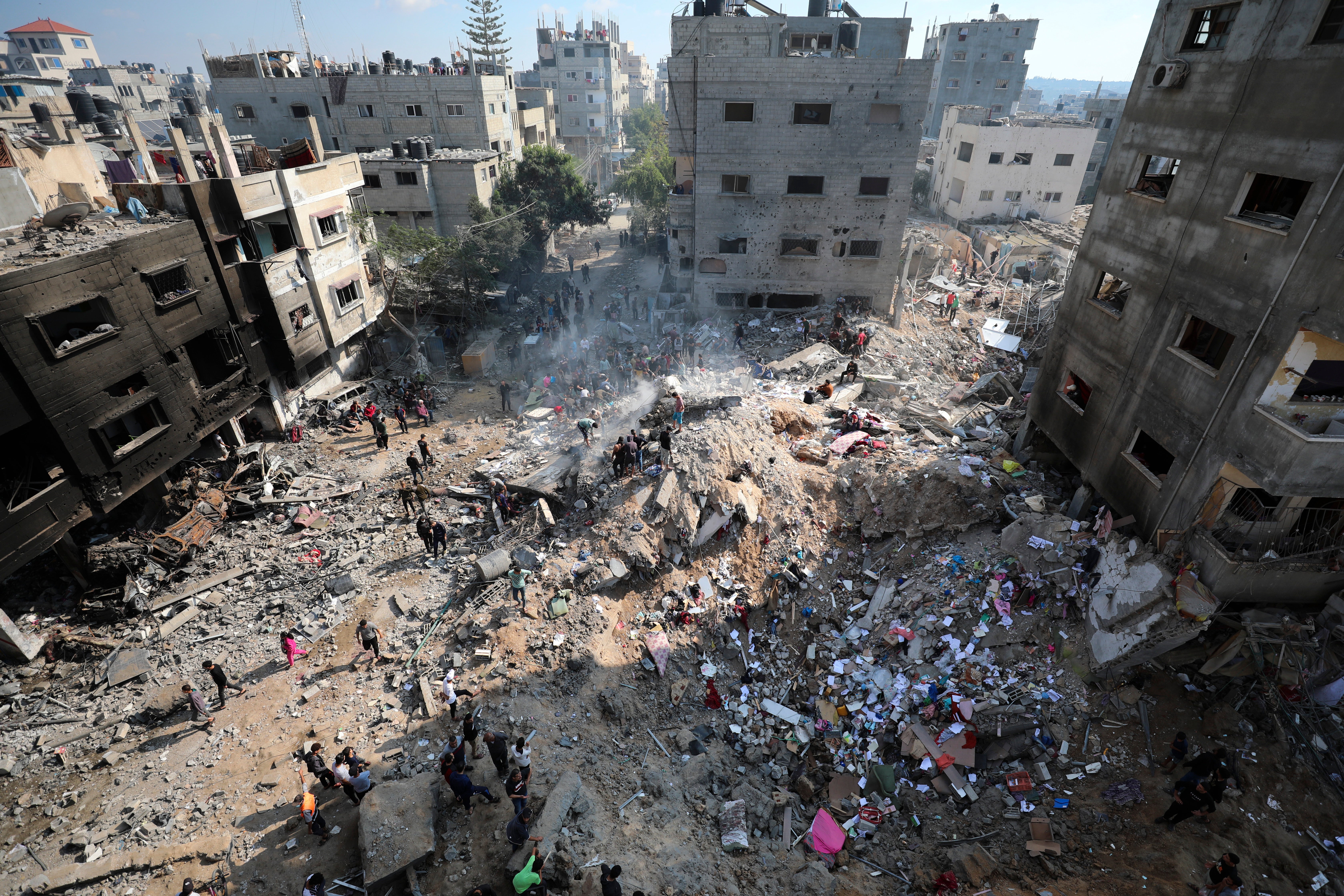 Palestinians look at destruction after an Israeli strike on the Gaza Strip in Nusseirat refugee camp, central Gaza Strip, Friday, 17 Nov 2023.