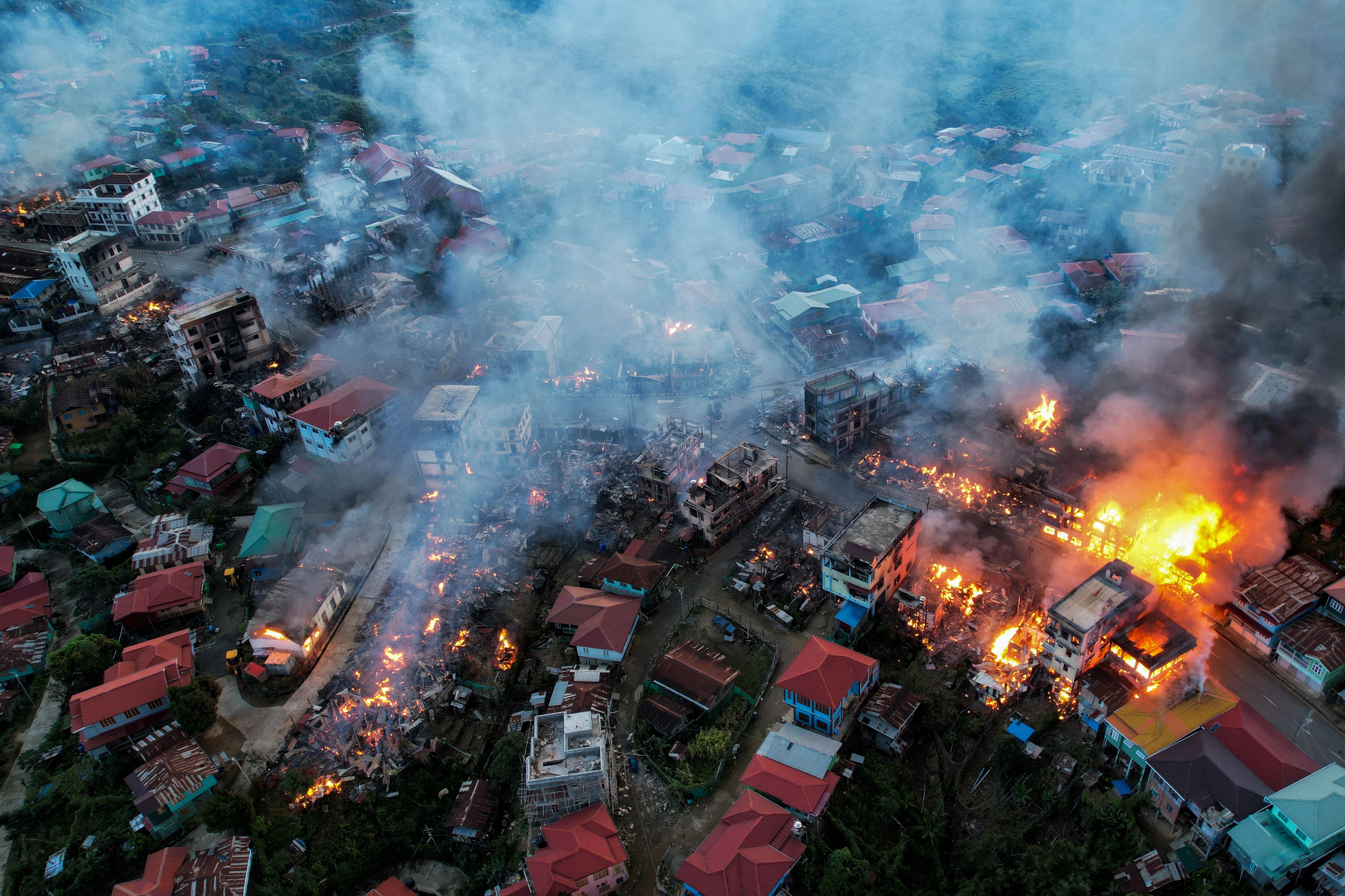 FILE: This aerial photo taken on 29 October 2021 show smokes and fires from Thantlang, in Chin State, where more than 160 buildings have been destroyed caused by shelling from Junta military troops, according to local media