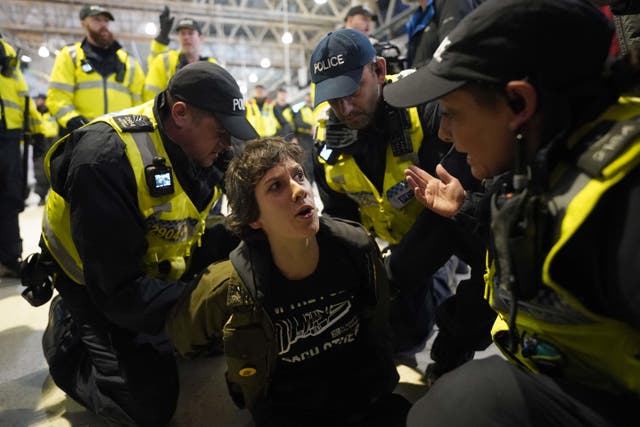 Police offiers detain a pro-Palestinian protester who took part in a sit-in demonstration at London’s Waterloo Station (Stefan Rousseau/PA)