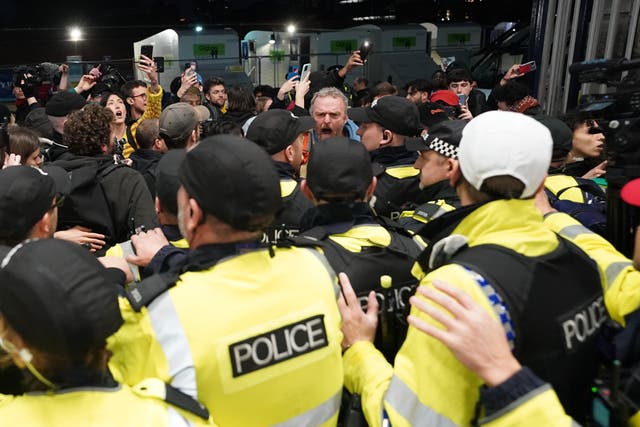 Police officers remove pro-Palestinian protesters that took part in a sit-in demonstration at London’s Waterloo Station (Stefan Rousseau/PA)