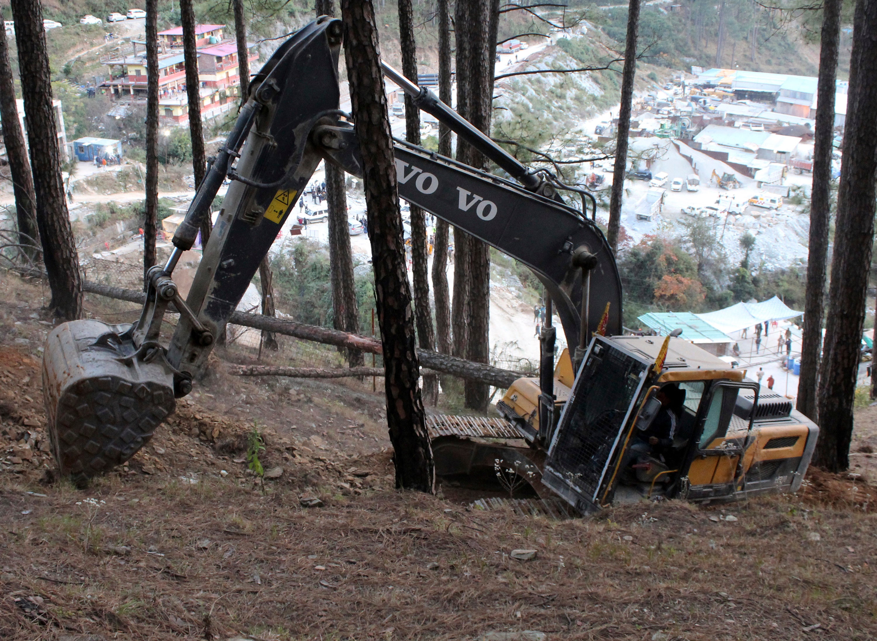 An earth-mover makes a vertical drill on the top of a mountain where a tunnel that collapsed in Uttarakhand state, India, Saturday, 18 Nov 2023.