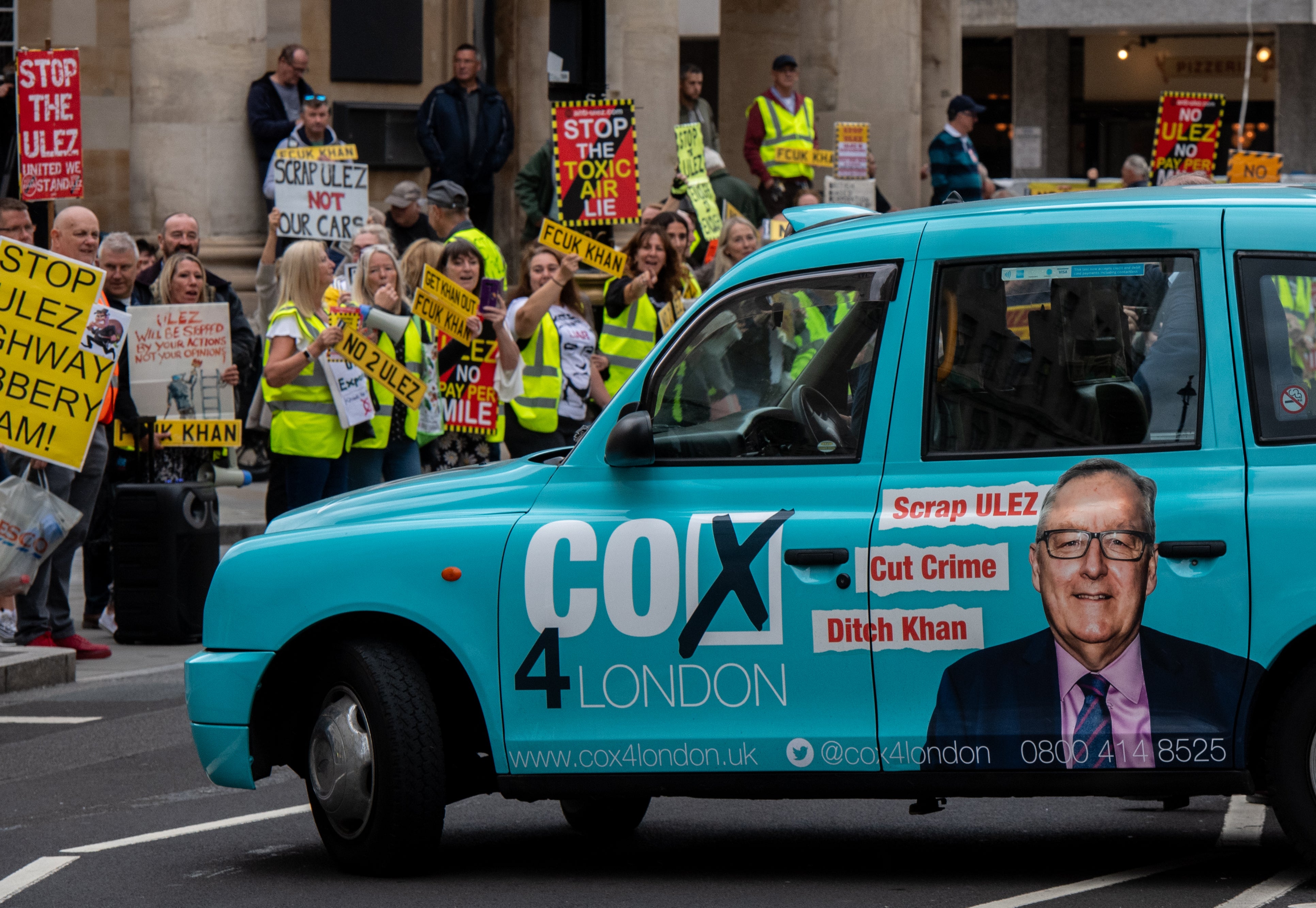 A taxi with an advert for Howard Cox