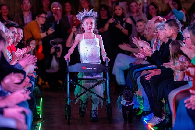 Nine-year-old Carmela Chillery-Watson, from Devizes, Wiltshire, takes part in the Bristol Fashion show with her walking frame. Picture date: Sunday November 19, 2023.