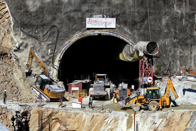 <p>Rescue workers stand at an entrance of the under construction road tunnel, days after it collapsed in the Uttarkashi district of India’s Uttarakhand state</p>