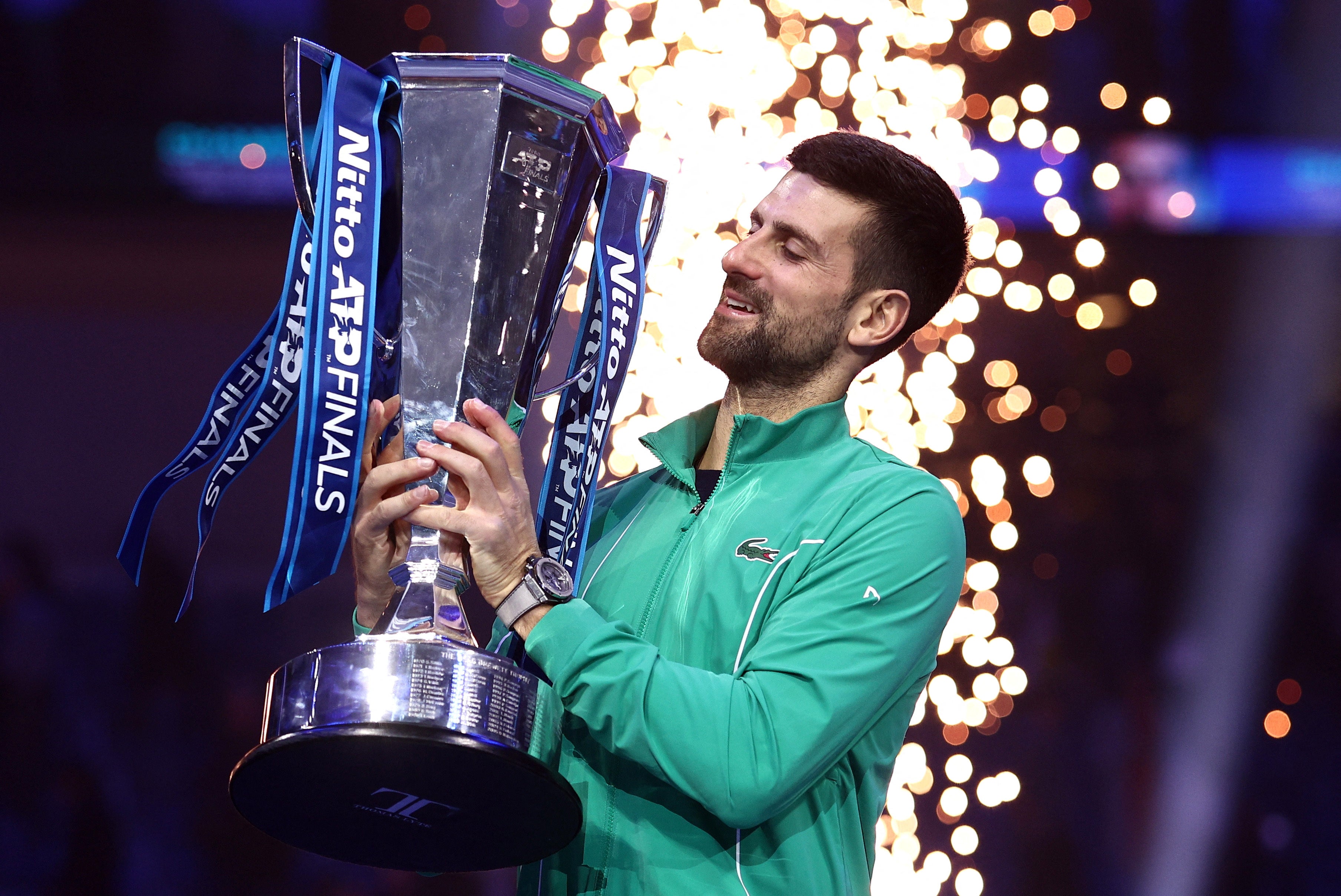 Djokovic celebrates with a trophy after winning the ATP Finals