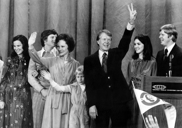 <p>Democratic presidential candidate Jimmy Carter (3rd R), flanked by his wife Rosalynn (3rd L), his daughter Amy (4th L) and family, flashes a victory sign during a rally in Atlanta. – Carter was elected on December 21, 1976</p><p>” top=”418″ width=”594″ format=”responsive” i-amphtml-layout=”responsive”><i-amphtml-sizer slot=