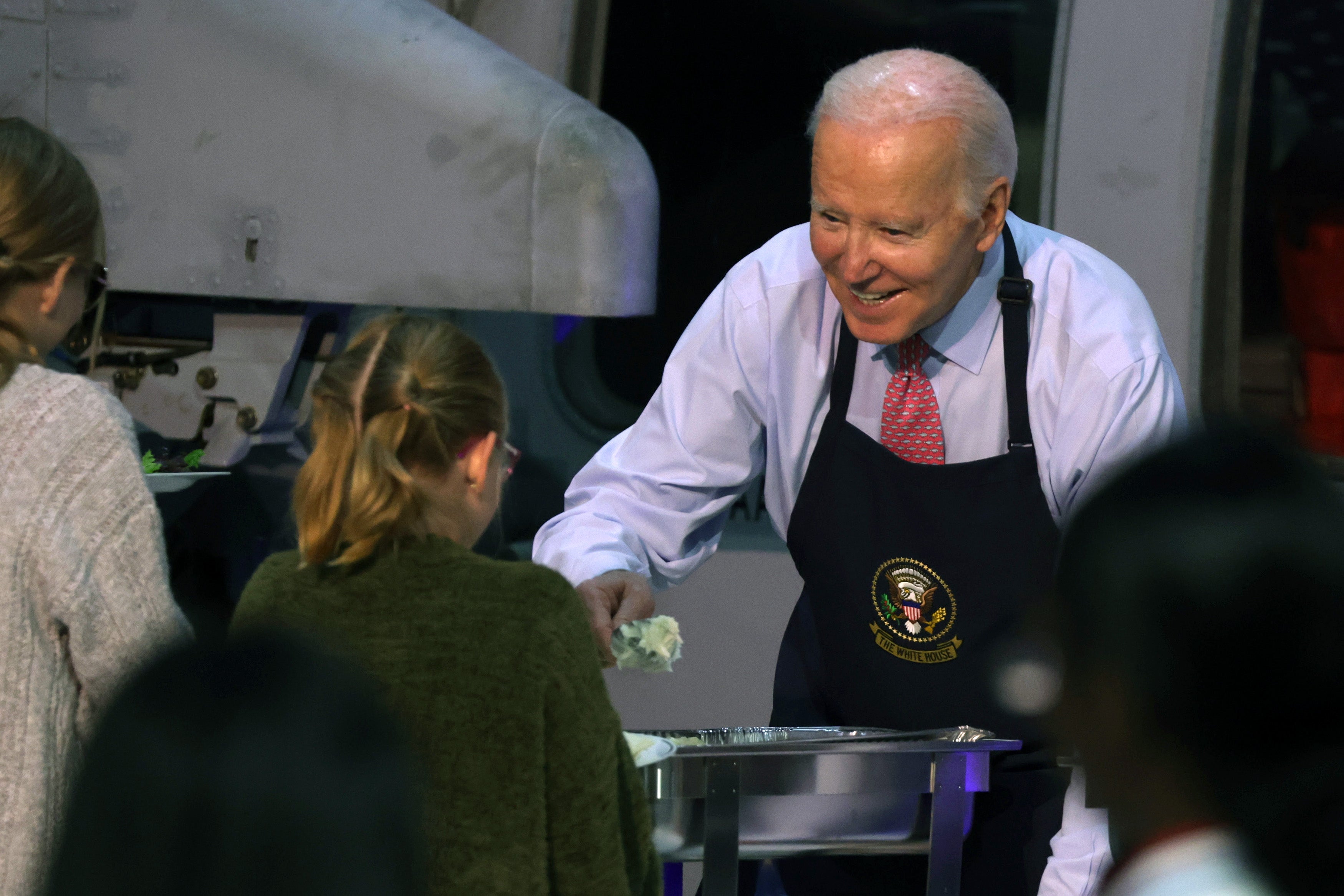 President Joe Biden serves service members and military families from the USS Dwight D. Eisenhower and the USS Gerald R. Ford during a Friendsgiving dinner event at the Norfolk Naval Station on November 19, 2023 in Norfolk, Virginia.