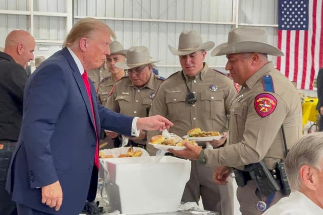 <p>Former President Donald Trump hands out Thanksgiving meals to officers working at the Southern Border as part of Operation Lone Star</p>