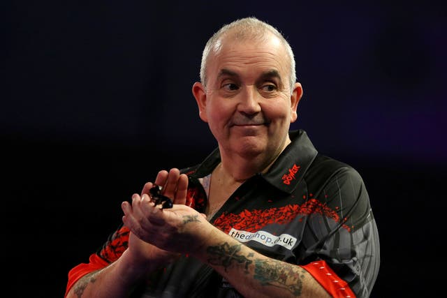 Phil Taylor will officially retire from competitive darts in 2024 (Steven Paston/PA)