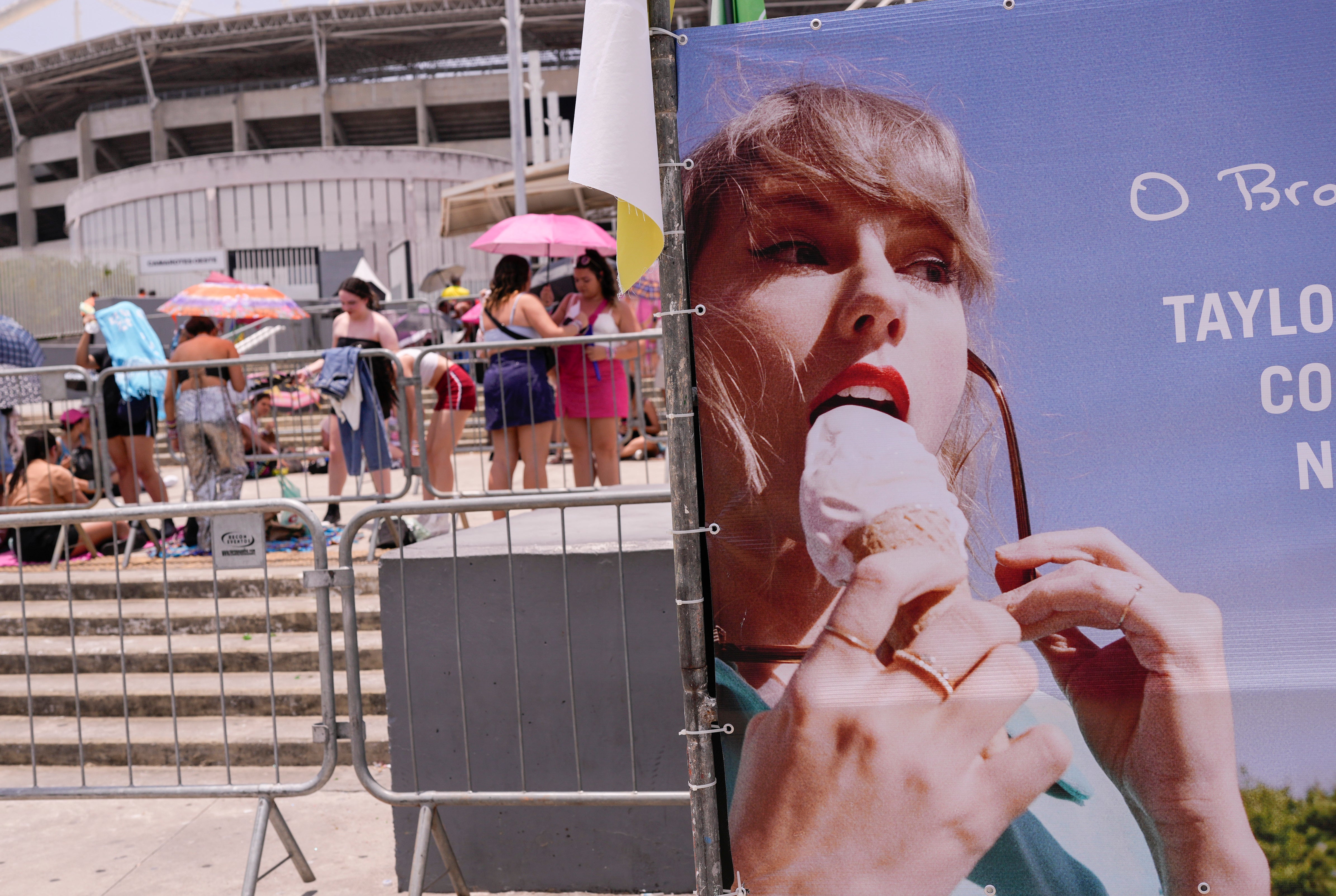 Taylor Swift fans wait for the doors of Nilton Santos Olympic stadium to open for her Eras Tour concert amid a heat wave