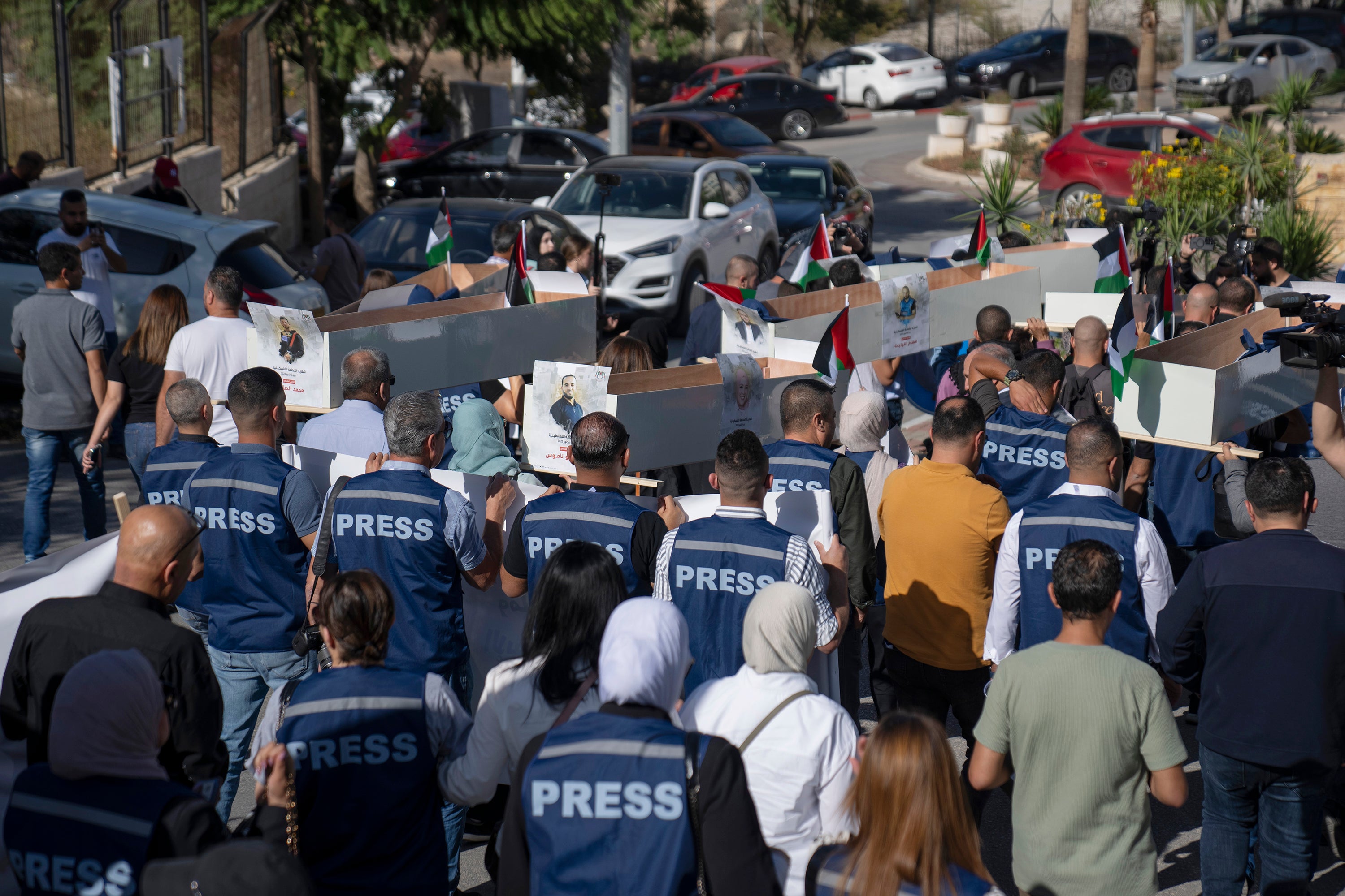 Palestinian journalists carried mock coffins of journalists killed during the war at a symbolic funeral in the West Bank on 7 November.