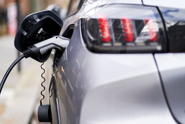 An electric car plugged into a EV charging point (John Walton/PA)