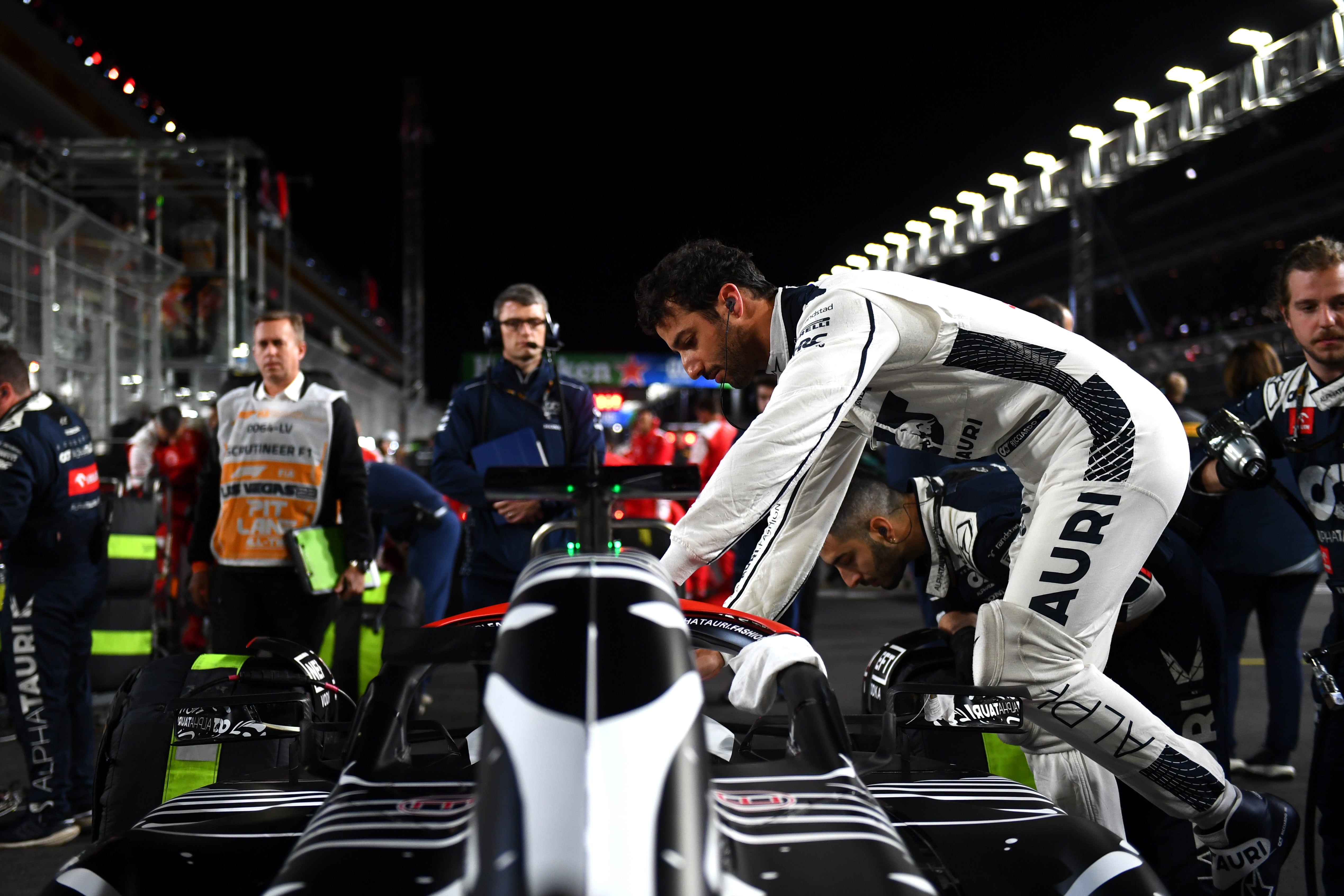 Daniel Ricciardo of Scuderia AlphaTauri jumps into his car on the grid