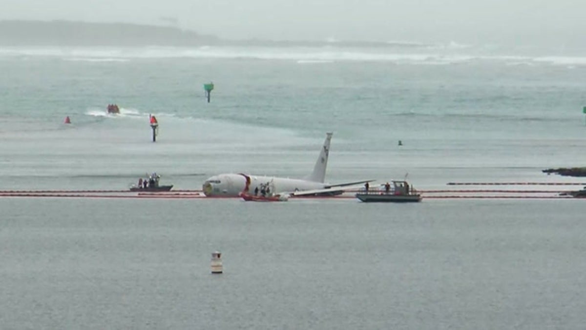 US military jet overshoots runway and crash lands in ocean off Hawaii