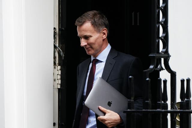 Jeremy Hunt faces competing demands from backbench Tory MPs as he prepares to deliver his autumn statement (PA)