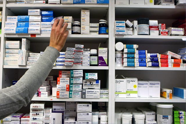A pharmacist stocks shelves at a chemist (Julien Behal/PA).