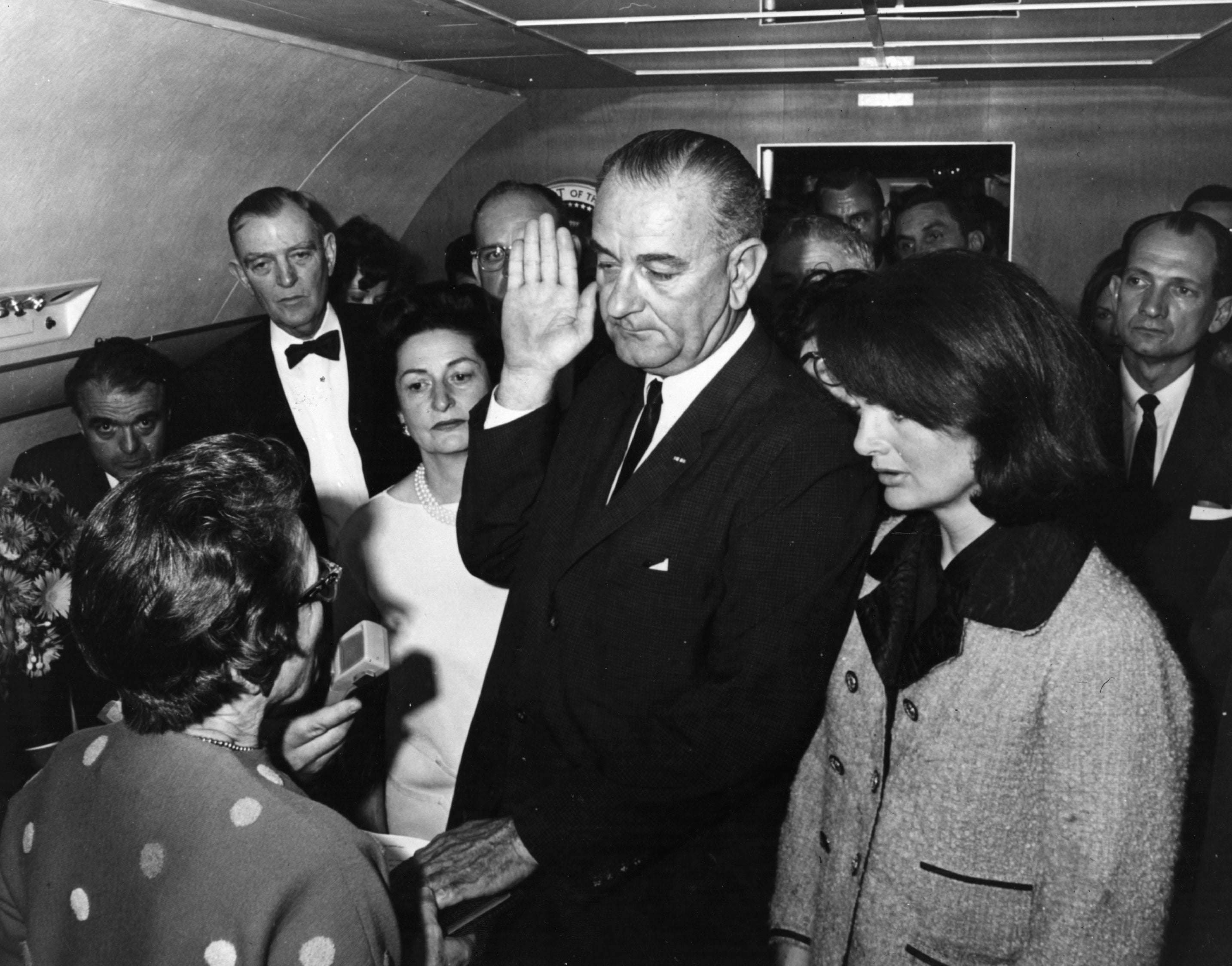 Kennedy’s vice president Lyndon Johnson is sworn in as the 36th President of the United States of America on board the presdential plane after Kennedy was pronounced dead