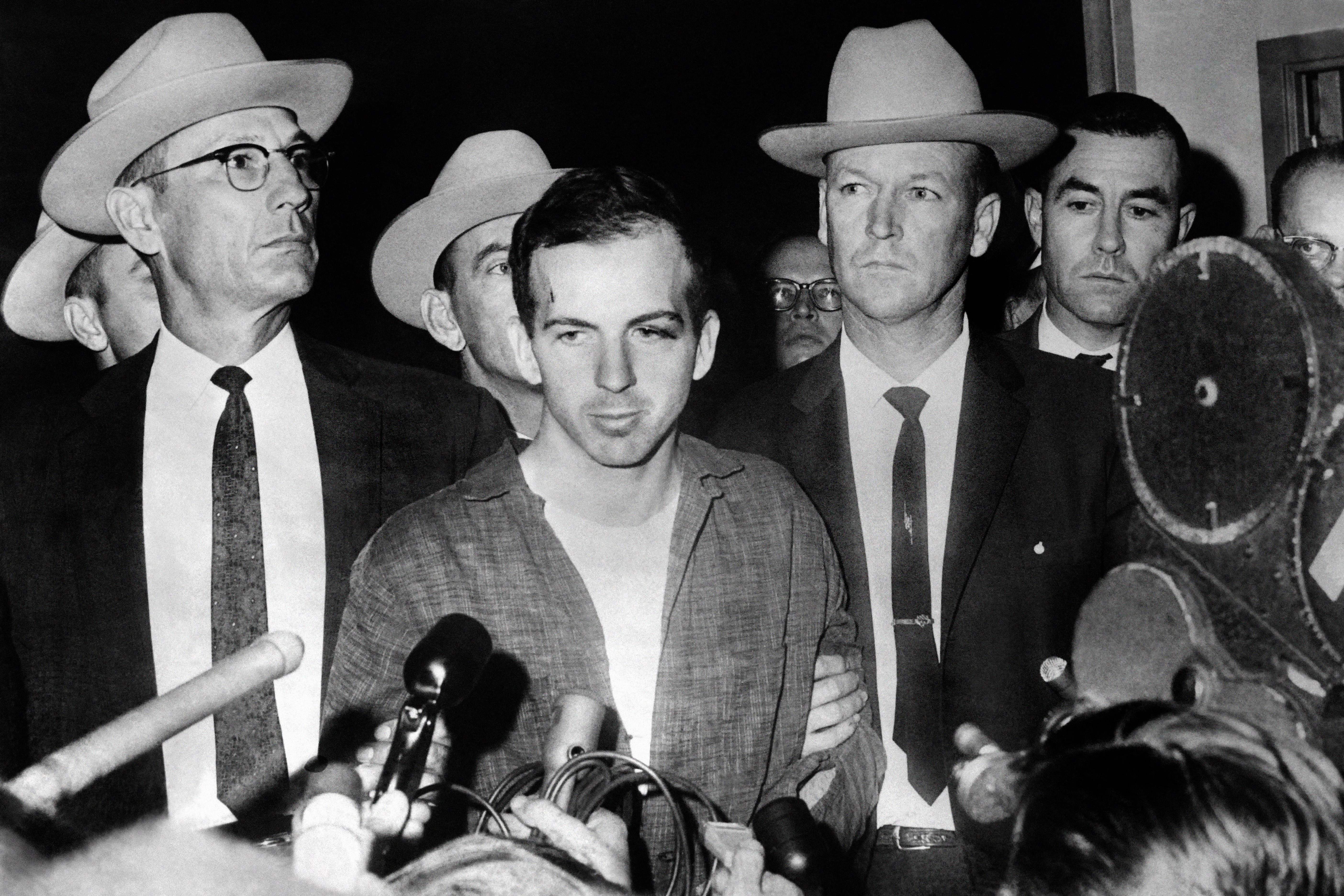 Assassination suspect Lee Harvey Oswald during a press conference after his arrest in Dallas – shortly before he too was shot dead