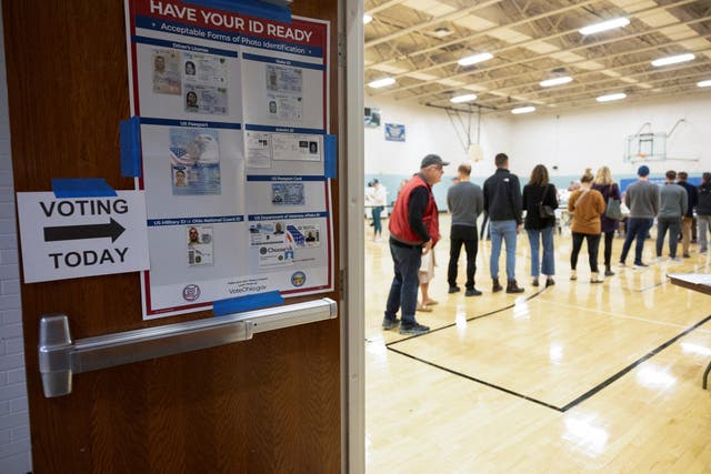 <p>Voters line up to cast their ballots in Ohio on 7 November. </p>