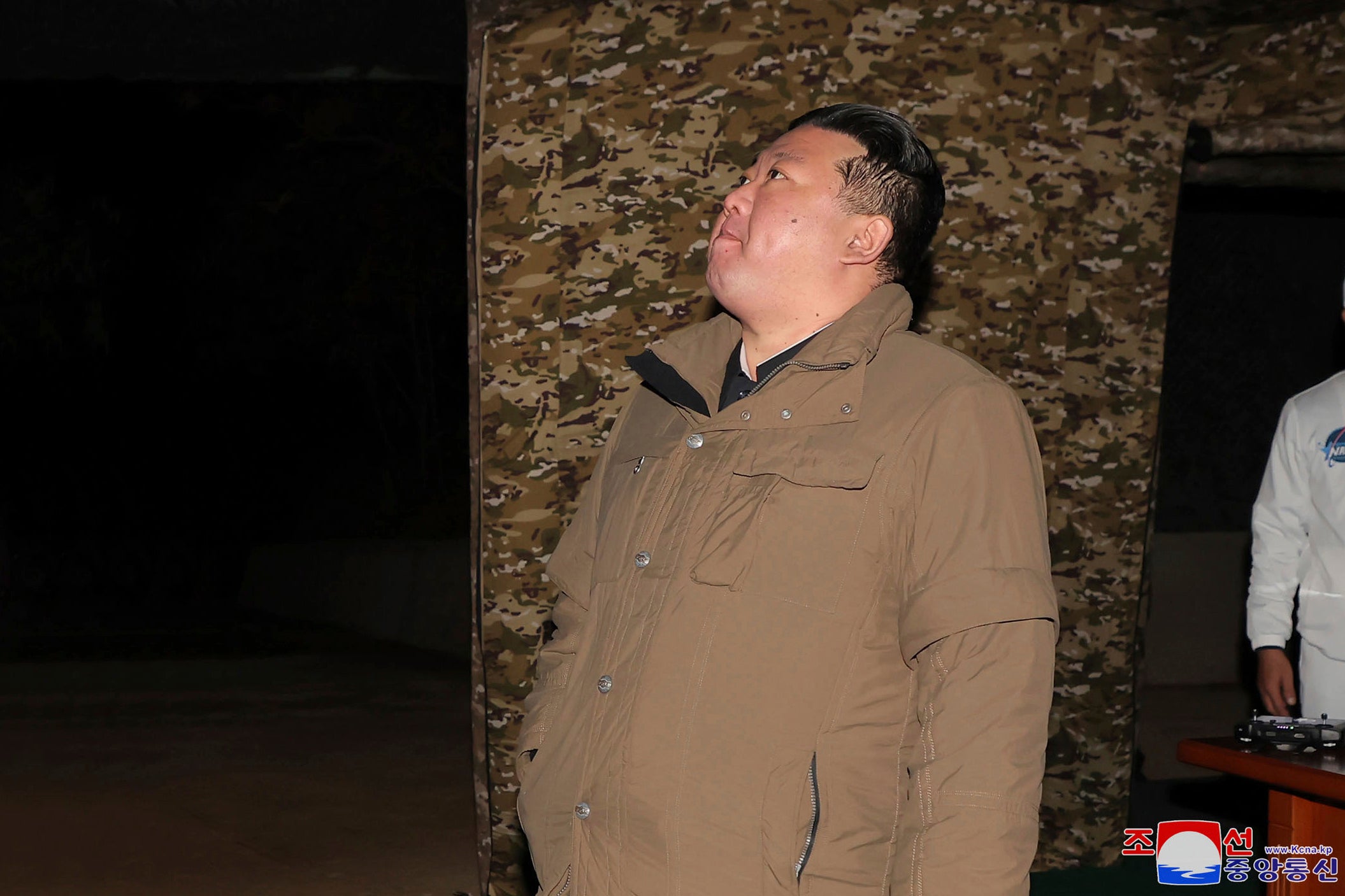 North Korean leader Kim Jong-un watches a rocket launch from a launching center in North Korea