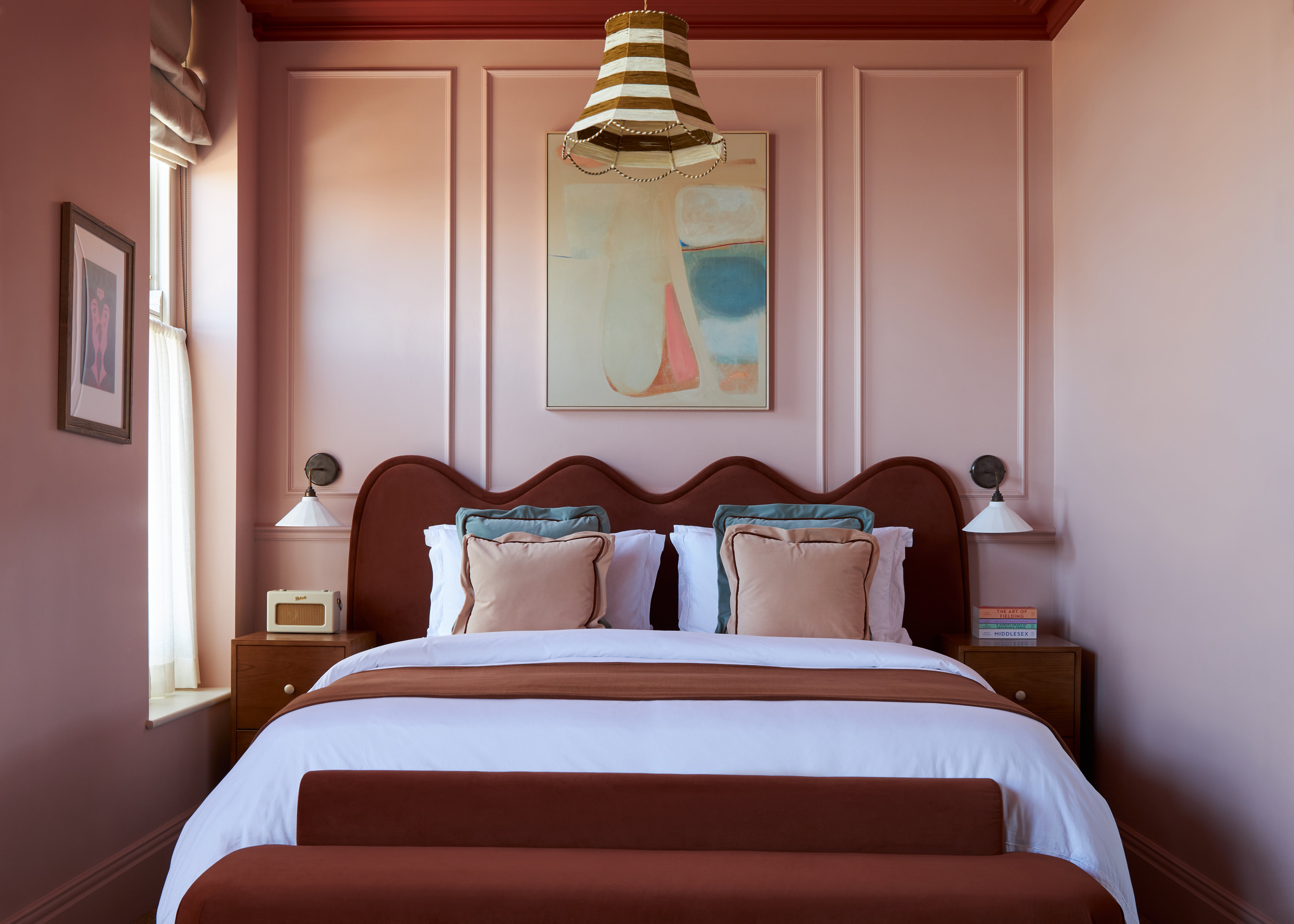Everything from skirting boards to ceilings is drenched in warm pink, terracotta and burgundy in the boutique hotel