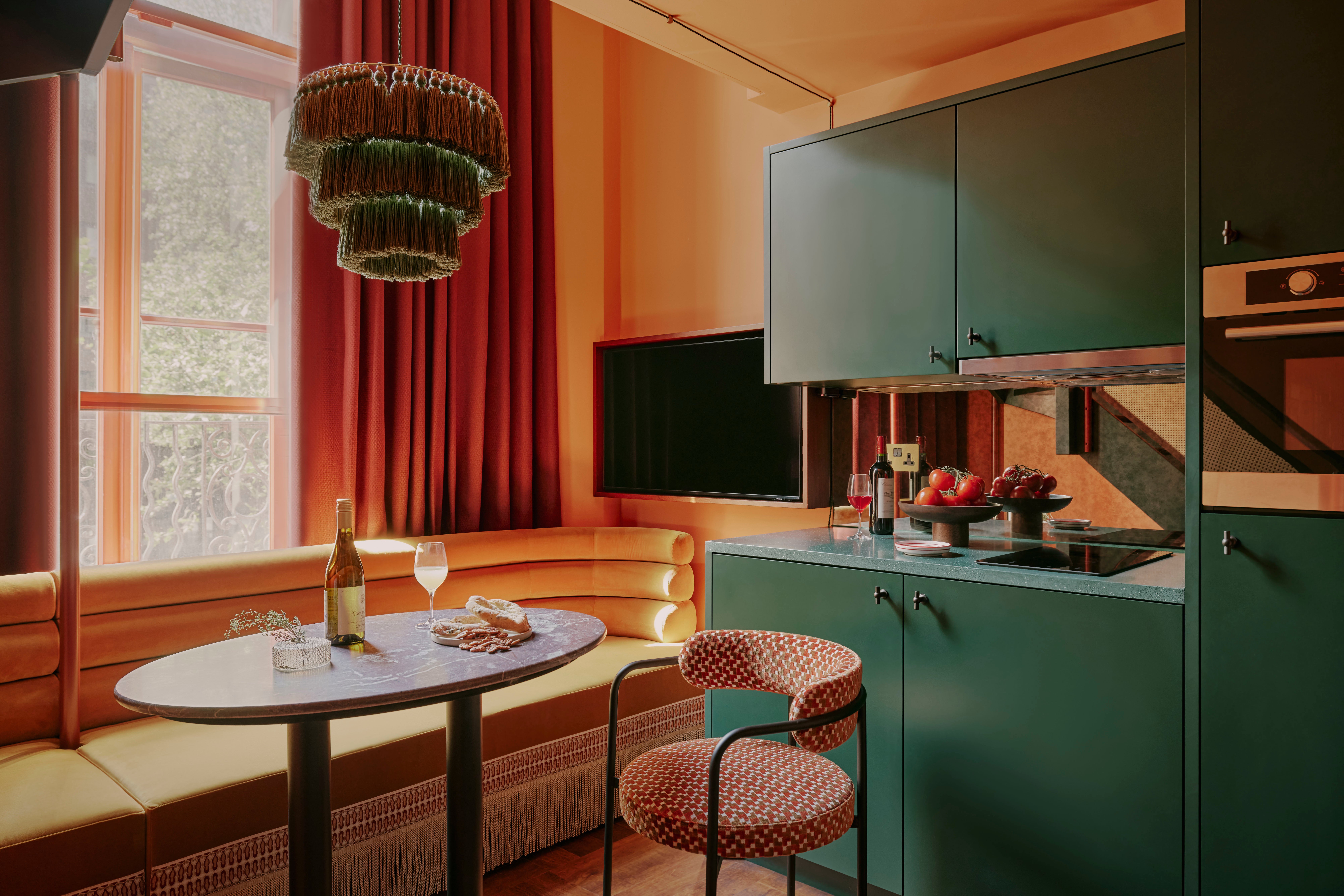 Licks of coral and teal paintwork accent home-from-home-feeling self-catering kitchens