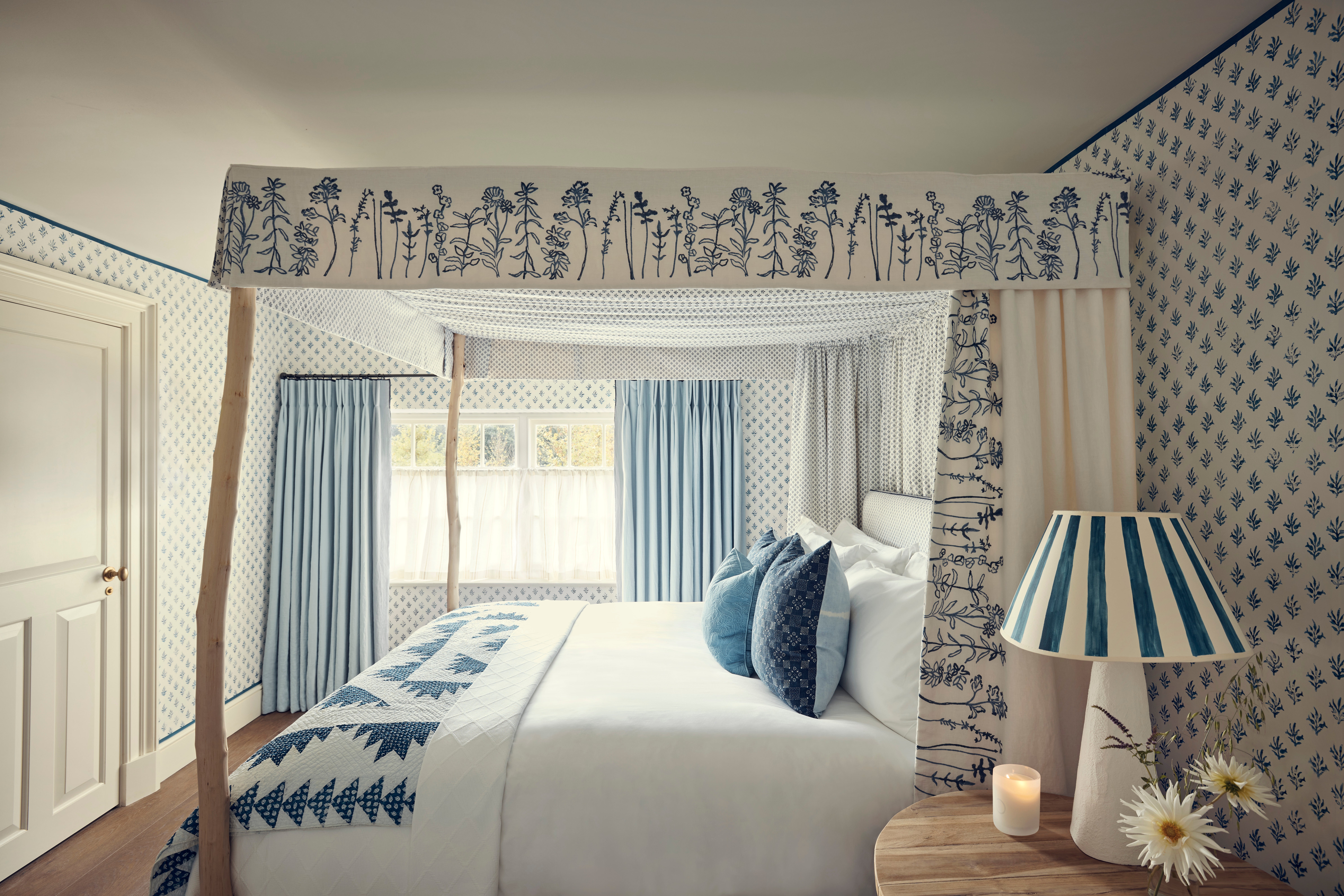 Inky blue accents, bloom-patterned pelmets and four-poster beds adorn The Bell’s bedrooms