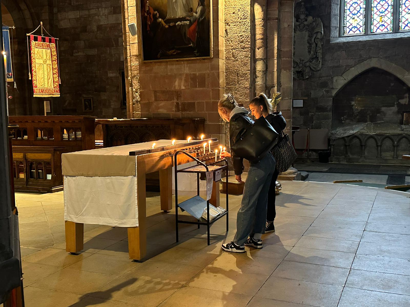 Teenagers from Shrewsbury College light candles at Shrewsbury Abbey in memory of the four young men who lost their lives in North Wales