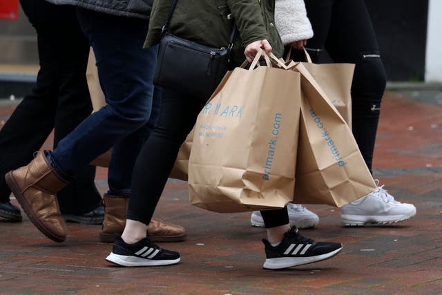 People carrying shopping bags (Andrew Matthews/PA)