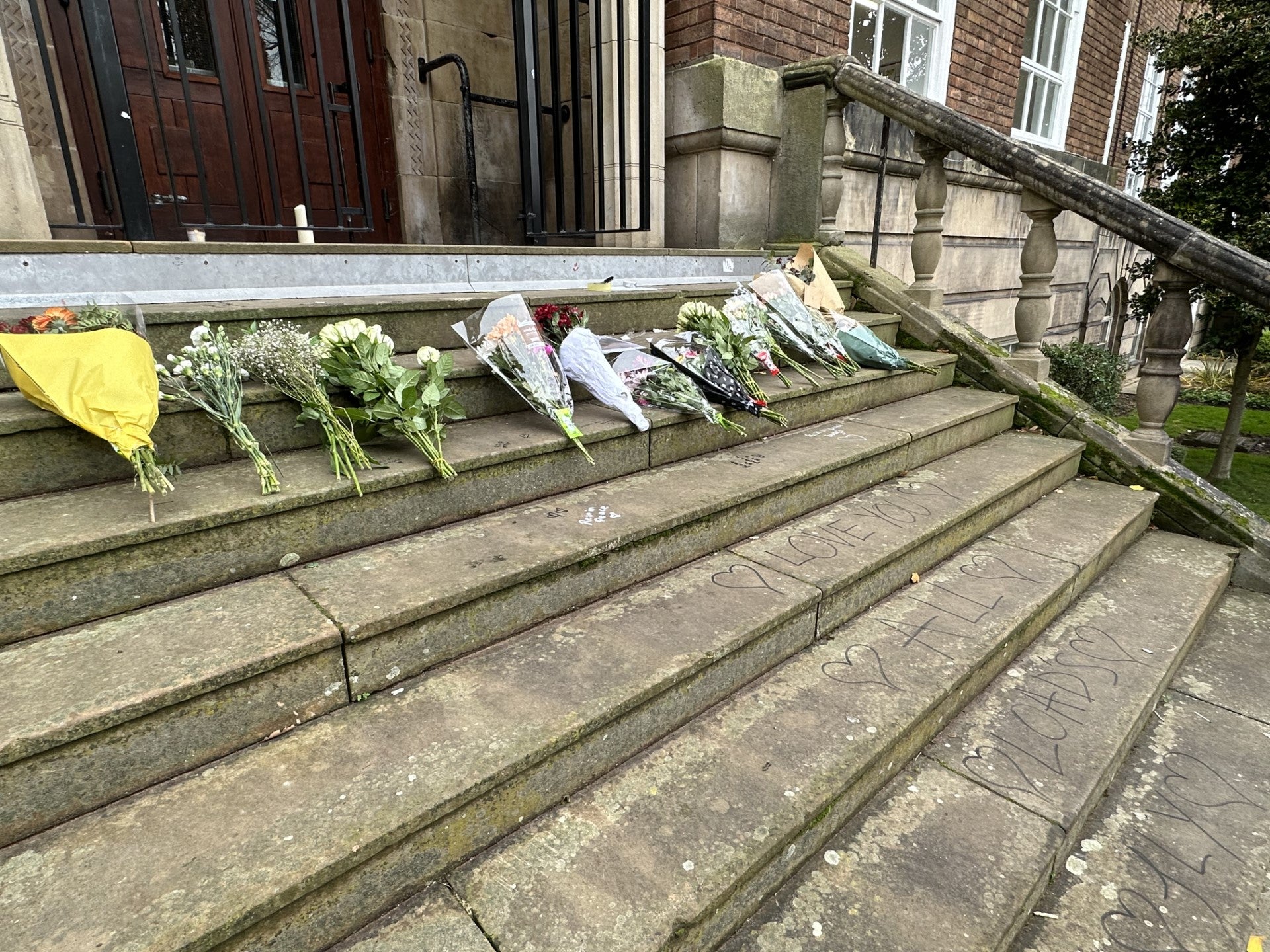 The words, ‘Love you all loads. Fly high’ were written on the stone staircase below a floral tribute at Shrewsbury College’s English Bridge campus