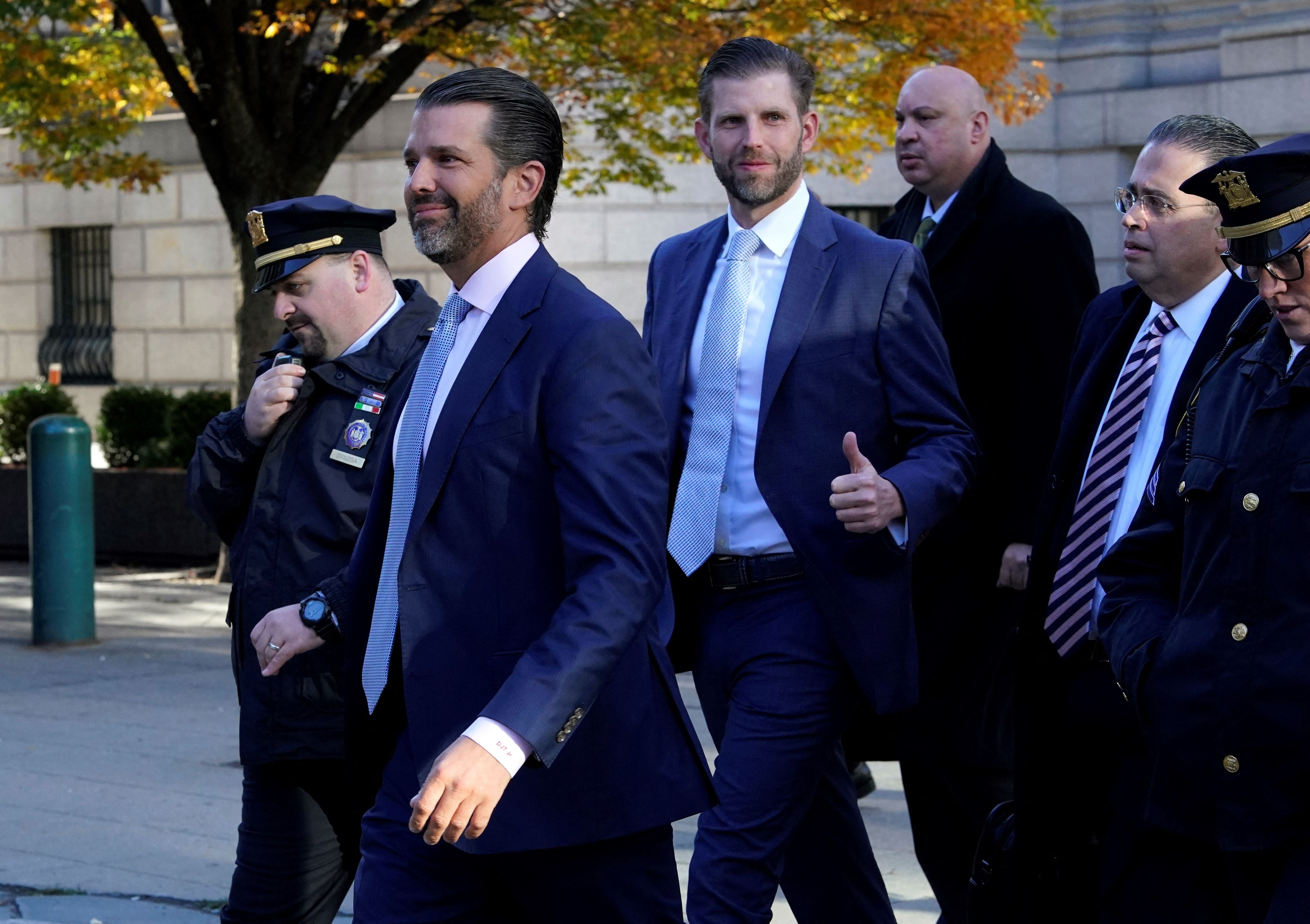 Donald Trump Jr and Eric Trump walk to the New York State Supreme Court building in Manhattan on 2 November for testimony in a civil fraud trial targeting the family’s business