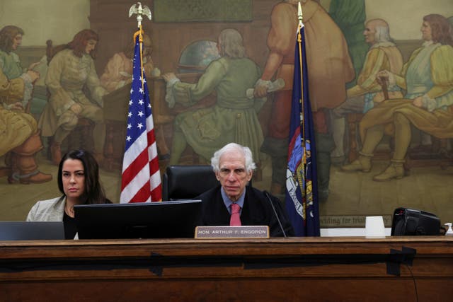 <p>New York Supreme Court Judge Arthur Engoron, center, sits behind the bench alongside his chief clerk Allison Greenfield on 2 November. </p>