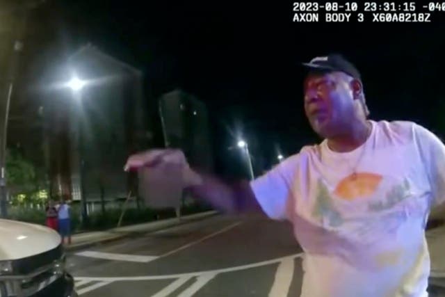 <p>This image from bodycam video provided by the Atlanta Police Department shows Johnny Hollman Sr. speaking with Officer Kiran Kimbrough on Aug. 10, 2023 in Atlanta</p>