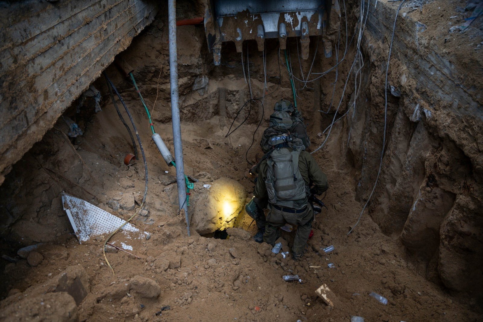 Israeli soldiers take position at what they say is a tunnel during the ongoing ground operation