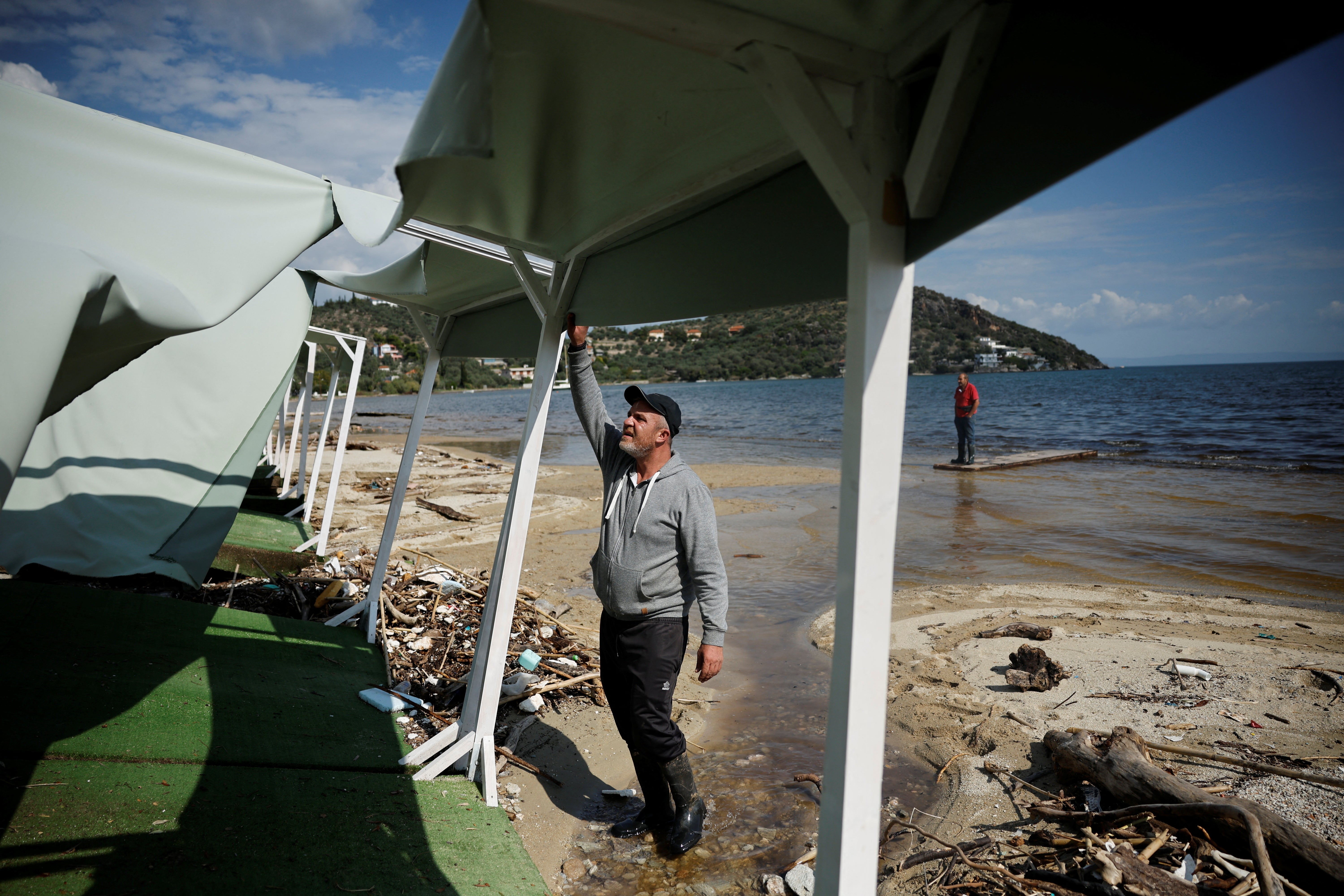 Tsiamitas inspects the damage at his beach bar in Chrissi Akti, also known as Golden Beach