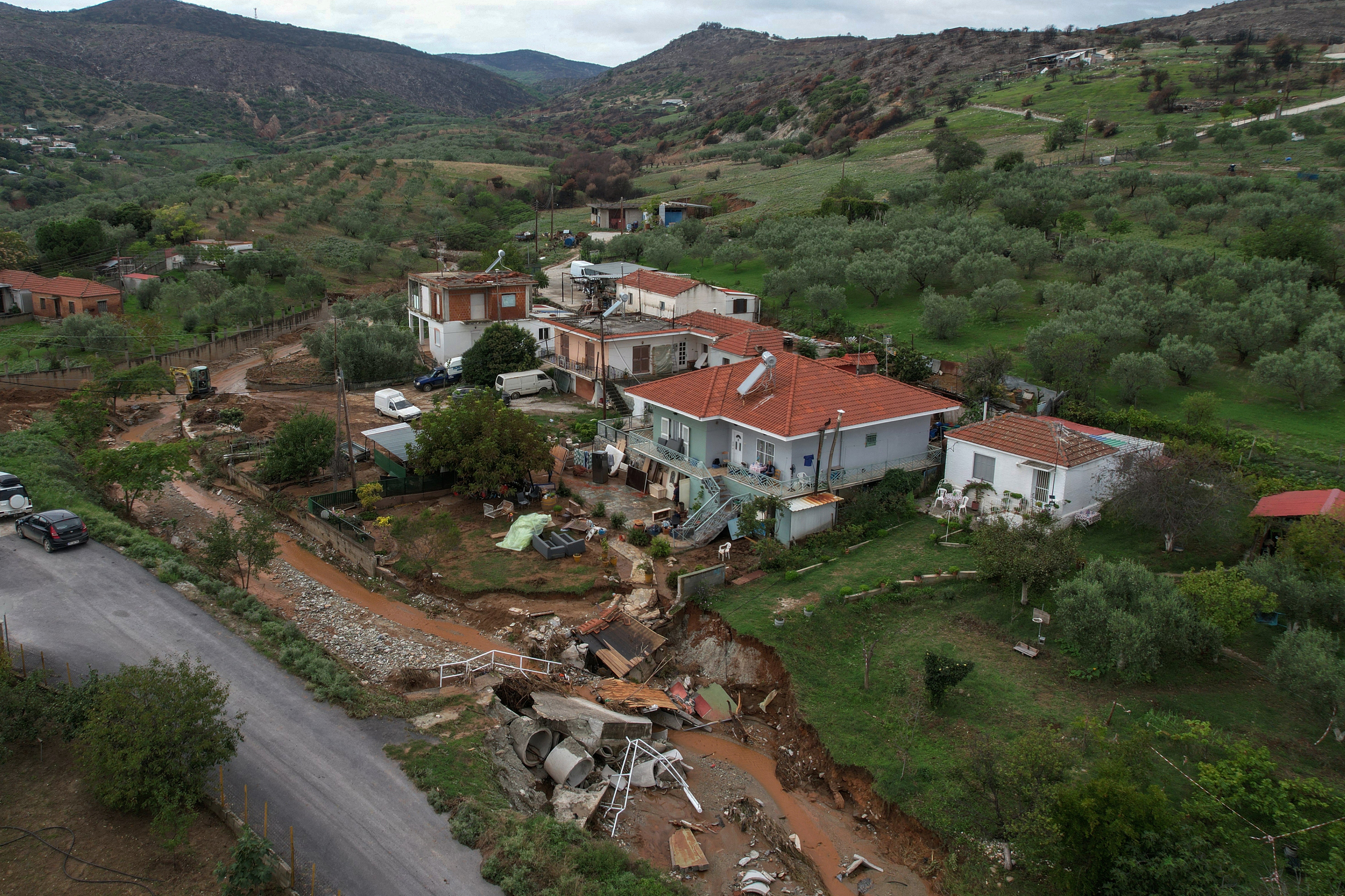 Debris is scattered in front of Vasilis Tsiamitas’s house after flooding hit Sesklo
