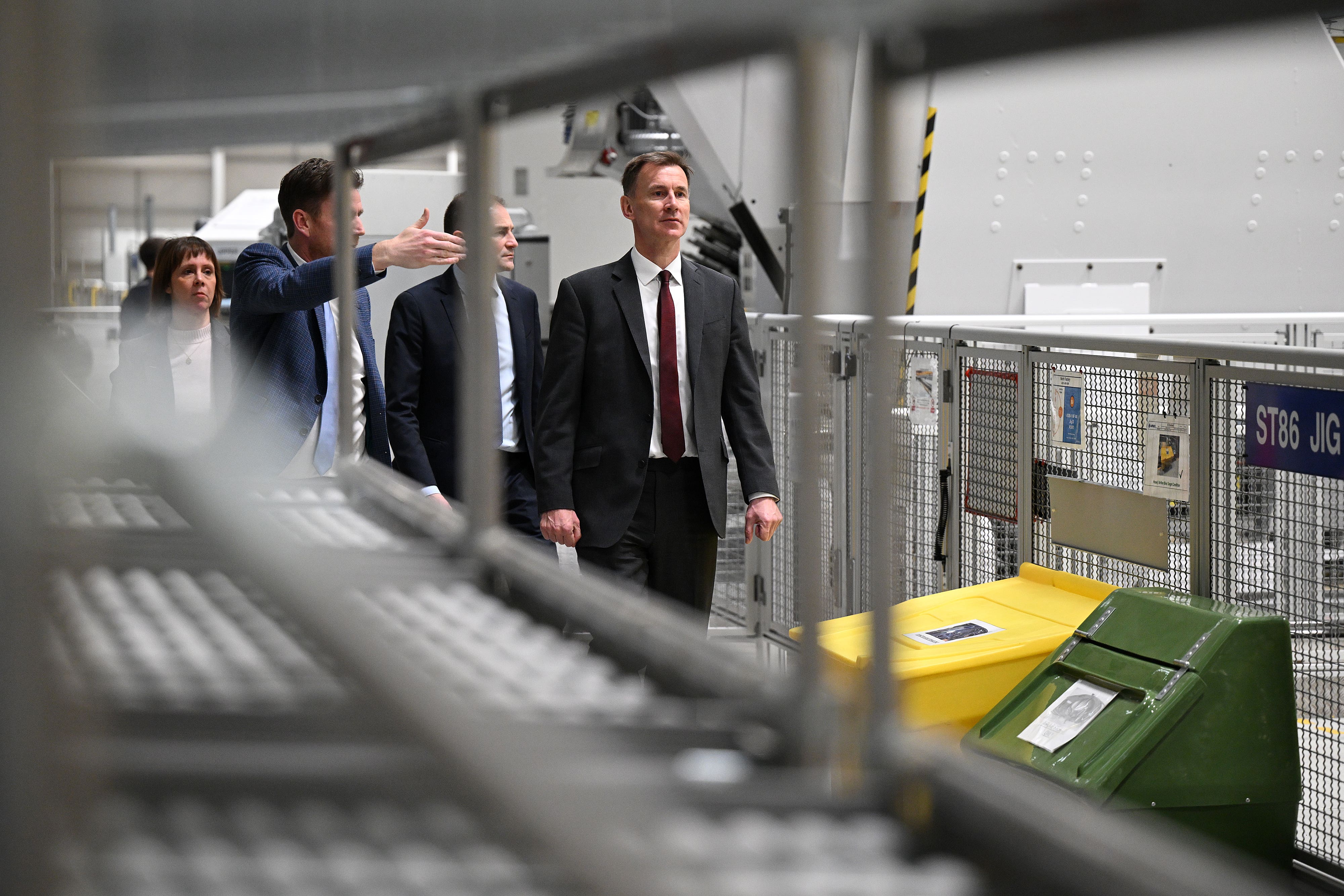 Jeremy Hunt (right) is shown the Airbus A350 wing manufacturing process during a visit to the Airbus North Factory in Chester (Oli Scarff/PA)