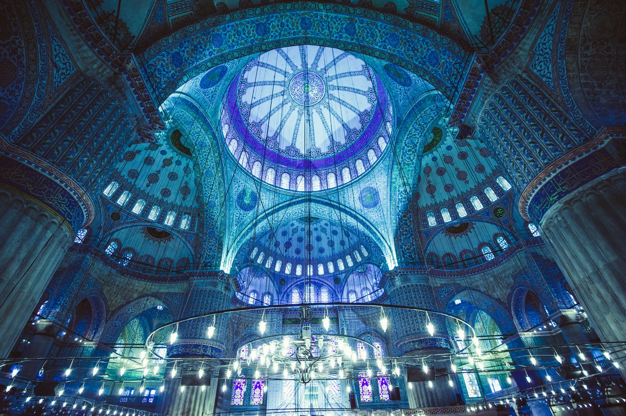Ornate tiles of cobalt and aquamarine decorate the interior of the Sultan Ahmed Mosque