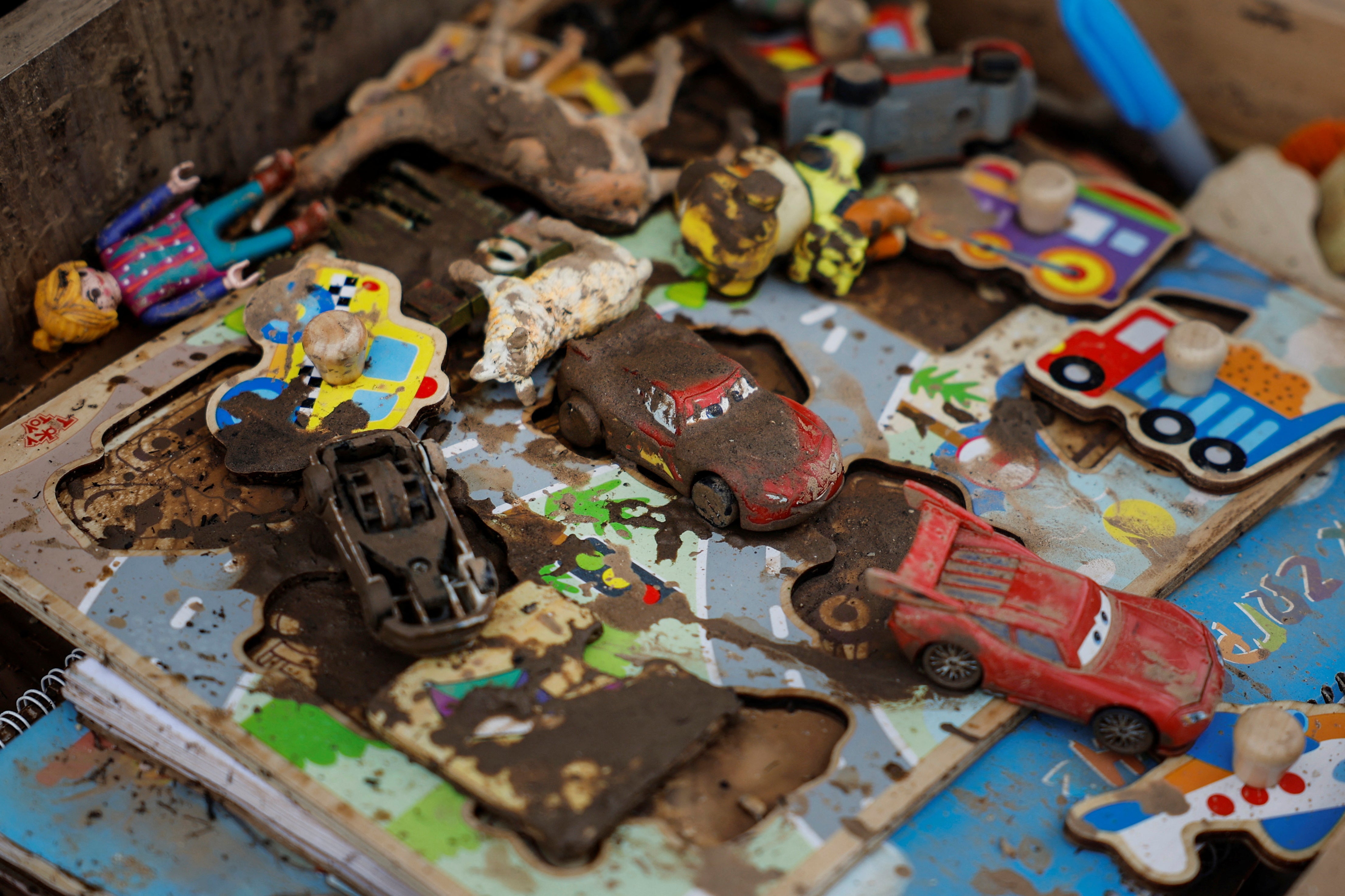 Children’s toys and books sit covered in mud at Tsiamitas’s house
