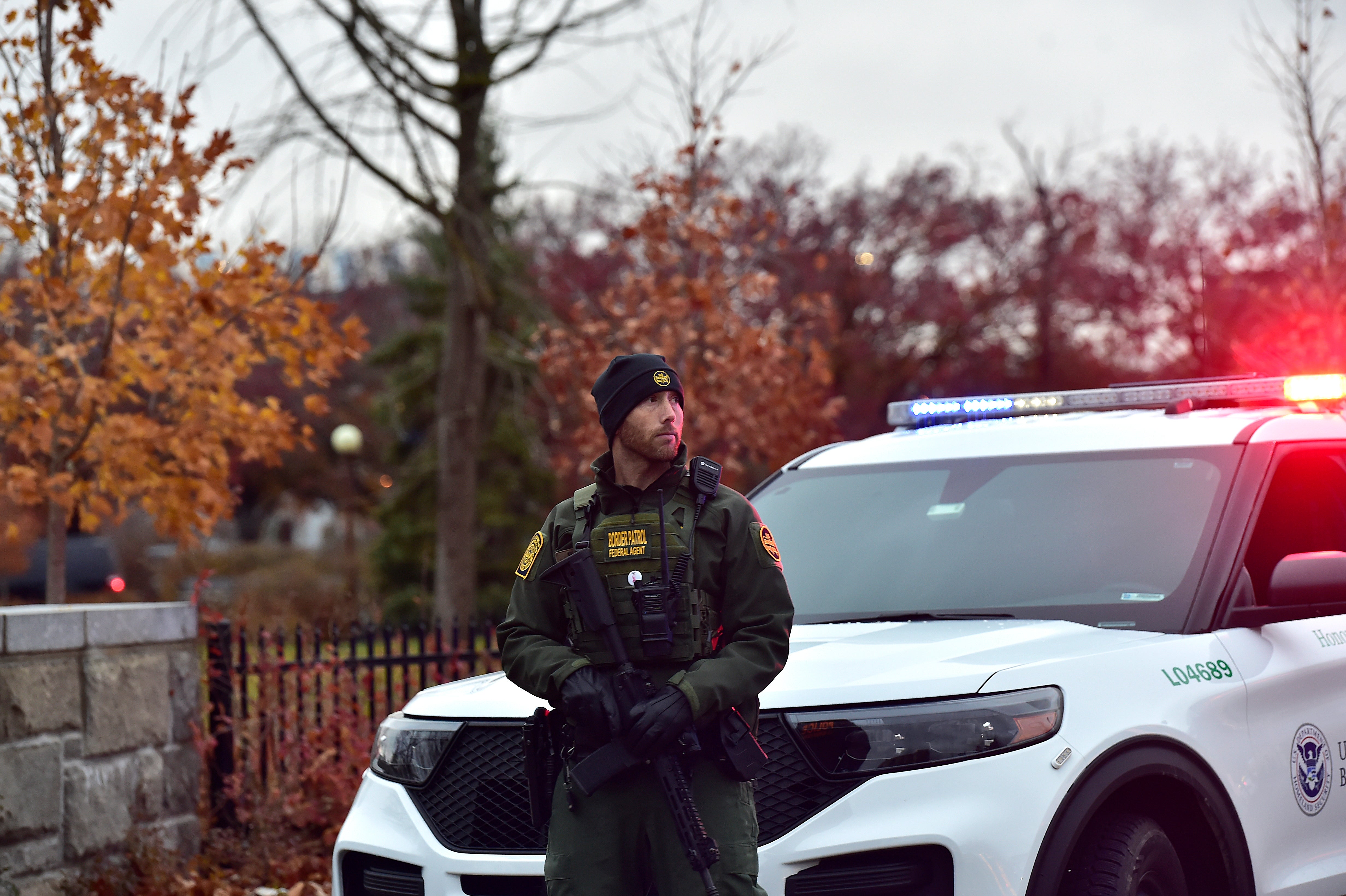 A member of the Border Patrol stands guard as Homeland Security, Border Patrol, and local authorities block traffic to the Rainbow Bridge
